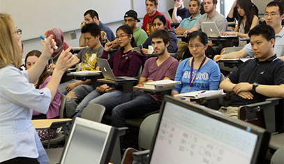 Image of a lecture with a professor and students.