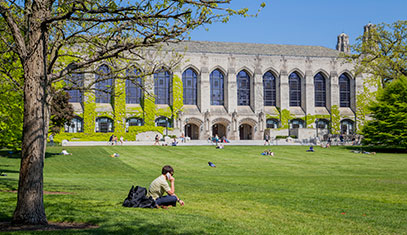 Image of a student sitting on the Northwestern lawn.